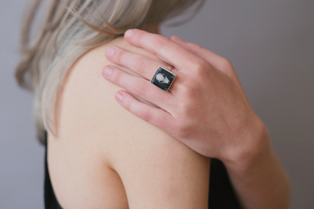 Model wearing bat skull ring