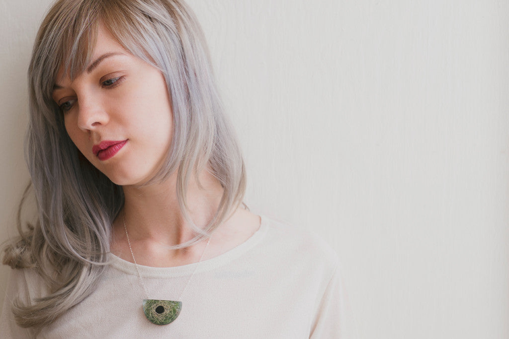 Model wearing nest necklace