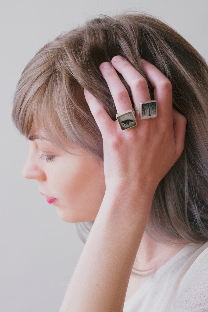 Model wearing fox and forest rings