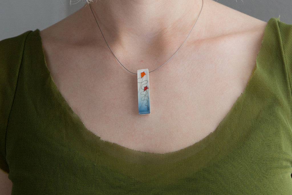 Model wearing red kites necklace